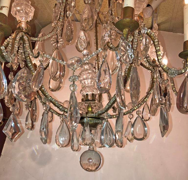 Close-up of chandelier crystals and ornate design.
