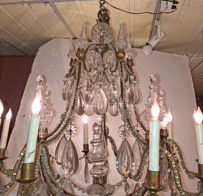 French chandelier lit up, detailed crystal decorations.