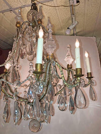 Side view of chandelier with ornate crystal drops.