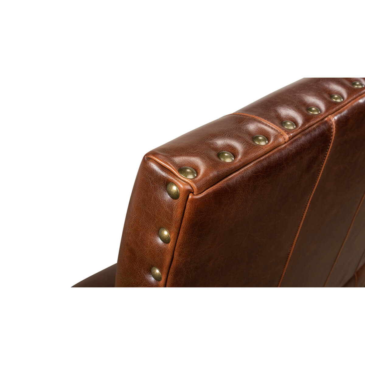 Detailed view of leather settee’s brass nailhead trim.