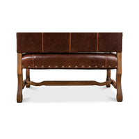 Bottom detail of leather settee, wooden leg support.
