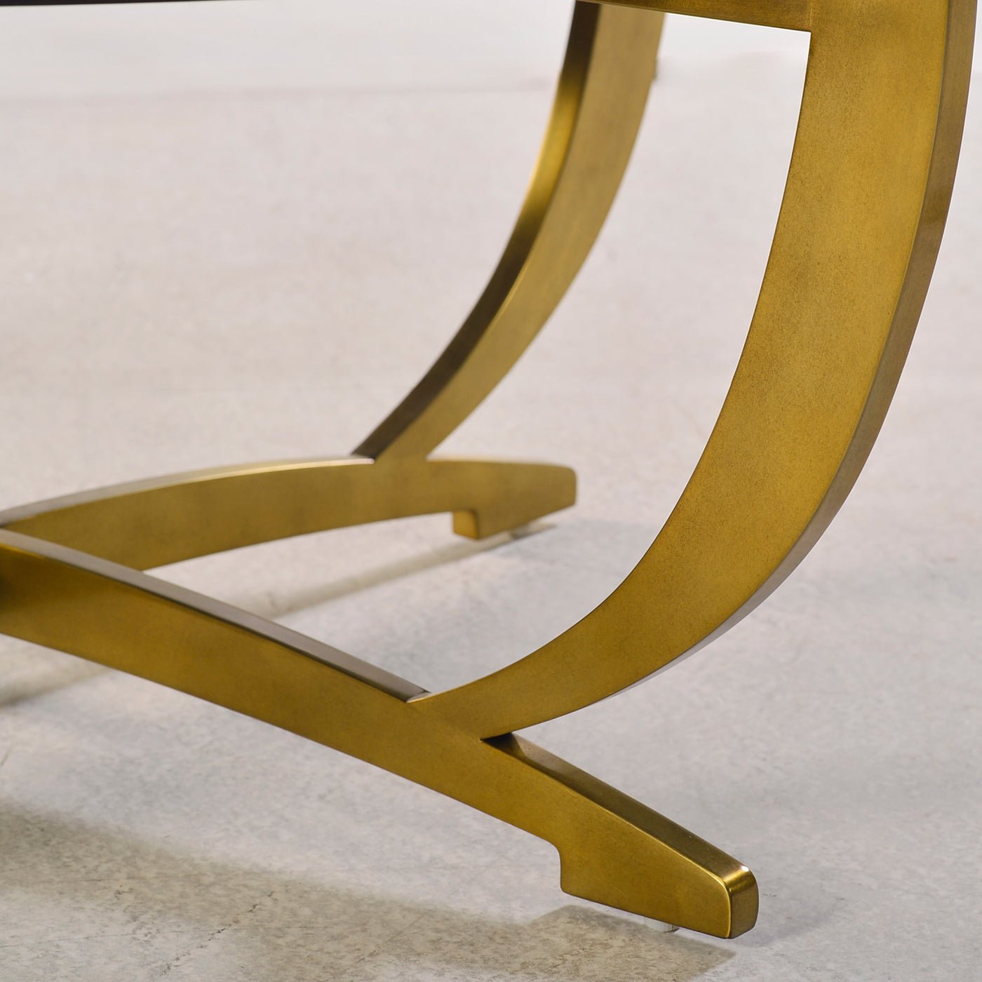 Gold leg detail on round side table, side view.