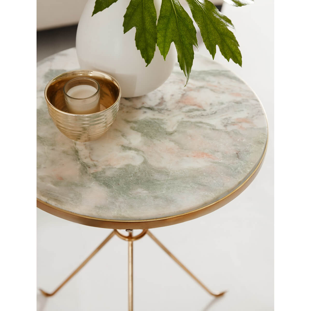 Close-up of marble top with decorative items.