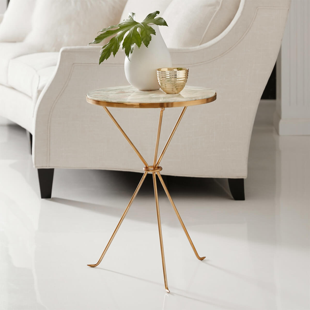 Accent table beside sofa with decor items.