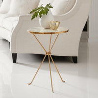 Accent table beside sofa with decor items.
