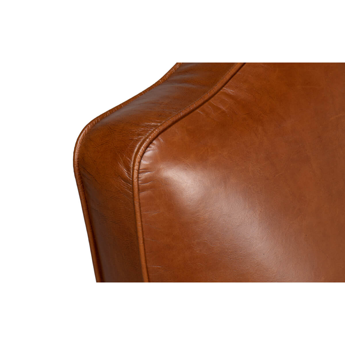 Backrest curve detail on brown leather club chair.