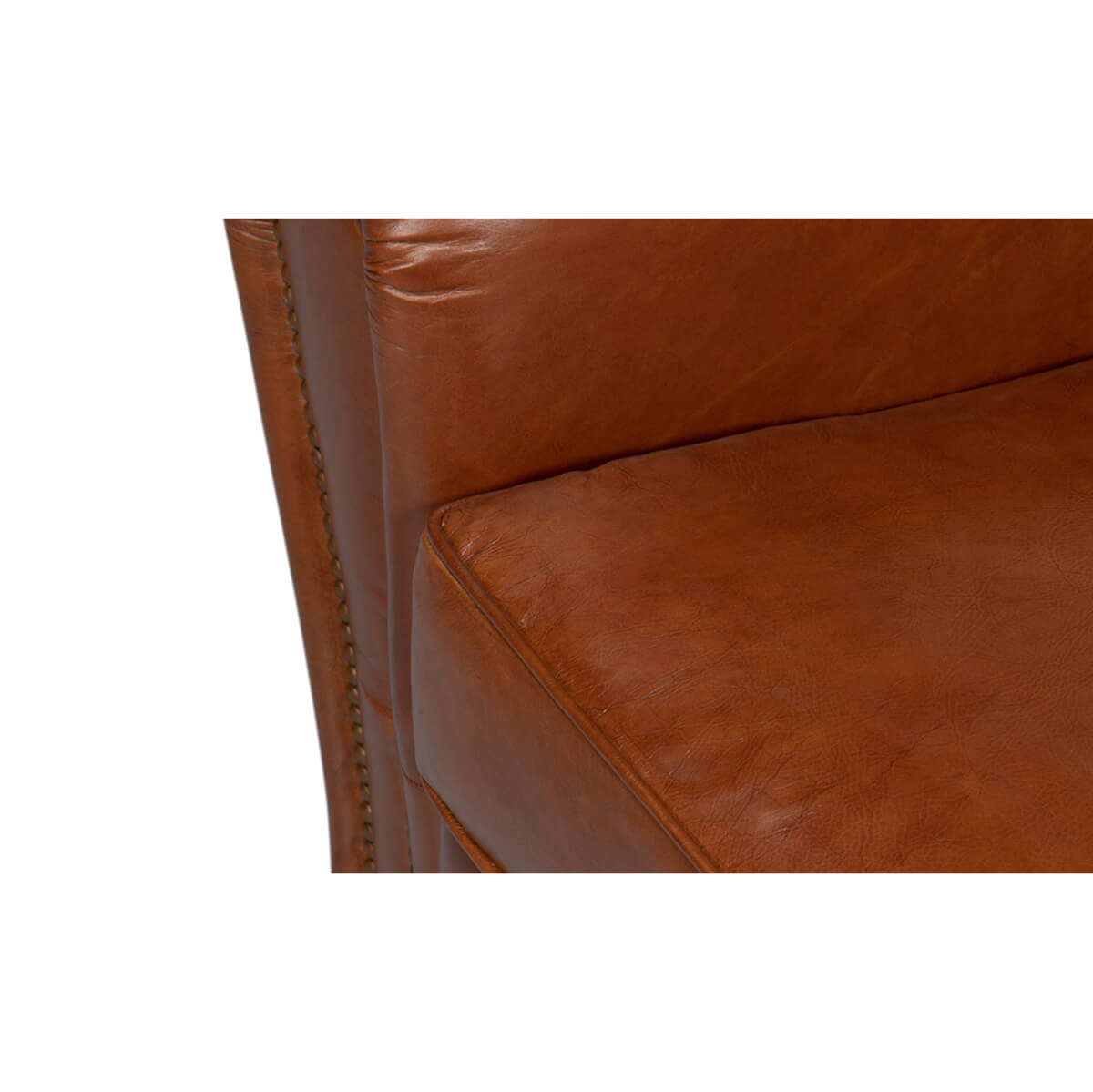Seat cushion detail on brown leather club chair.