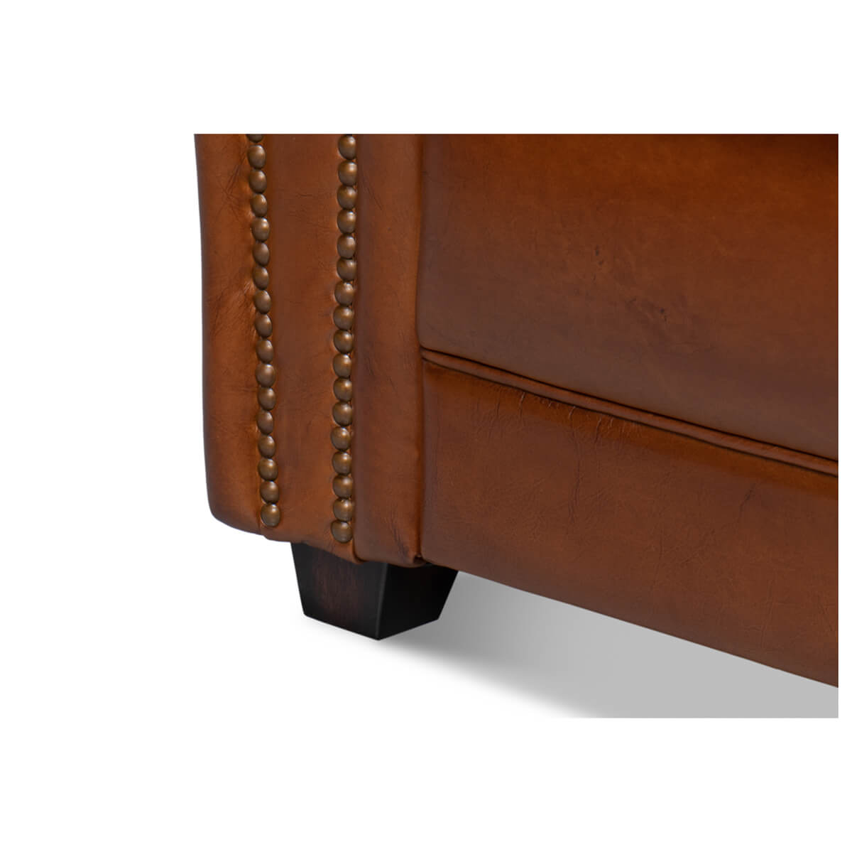 Nailhead trim and leg detail on club chair.