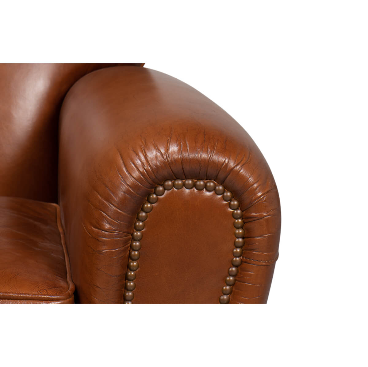 Nailhead trim detail on club chair armrest.