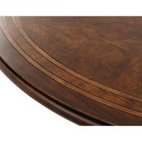 Close-up of inlay design on wooden dining table surface.