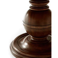 Detailed view of decorative pedestal base on dining table.