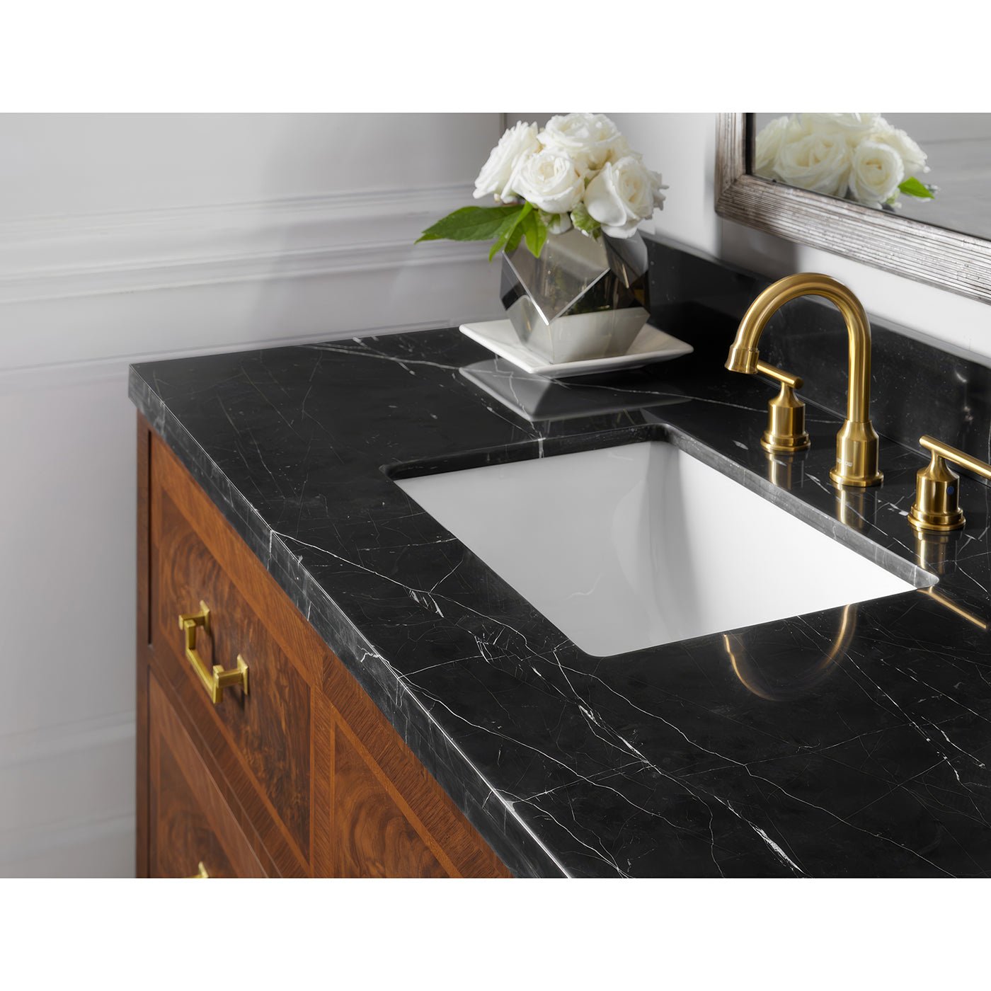 Close-up of vanity marble countertop and sink faucet.