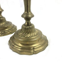Detailed base of French candlestick, ornate design in bronze.