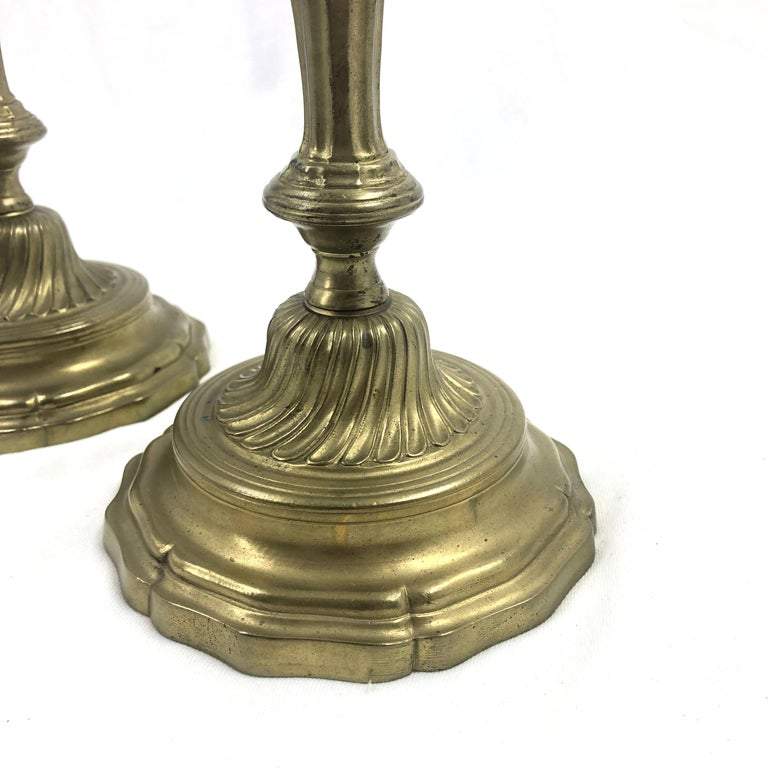 Detailed base of French candlestick, ornate design in bronze.
