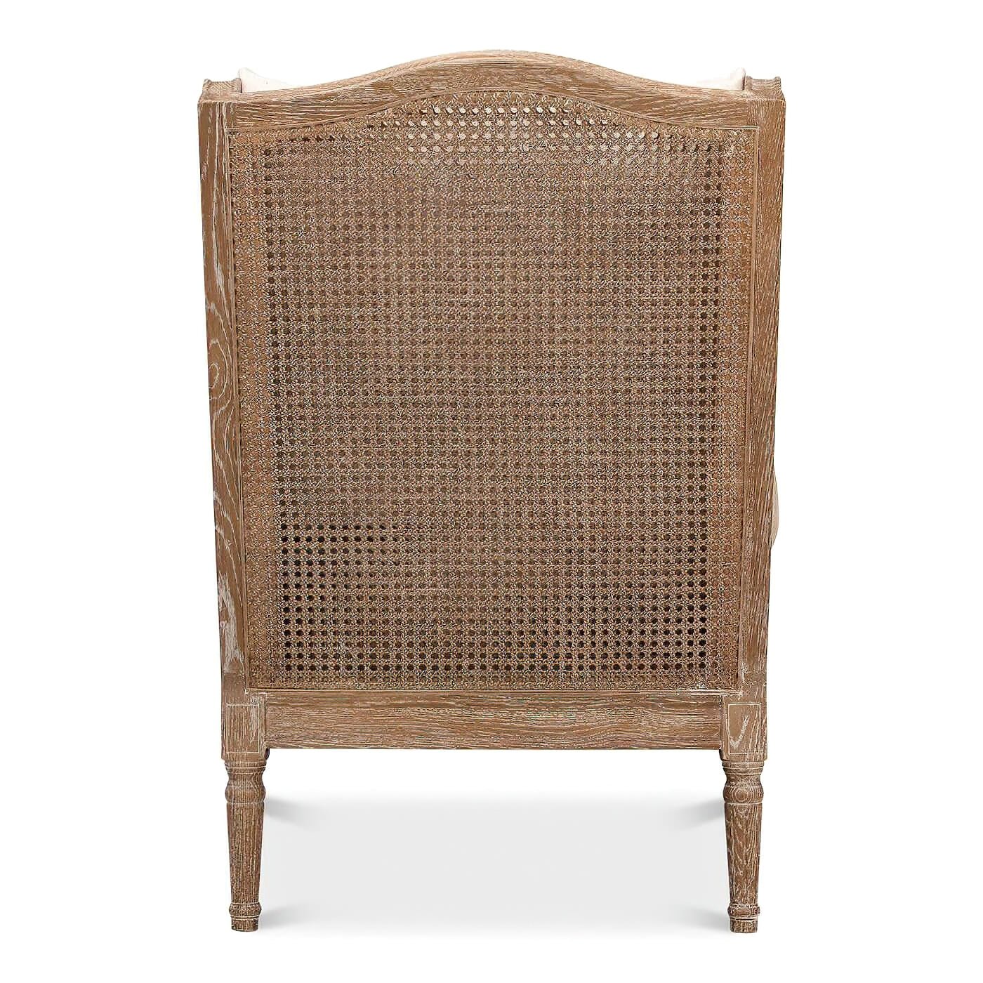 Back view of French caned armchair, showcasing cane detail.