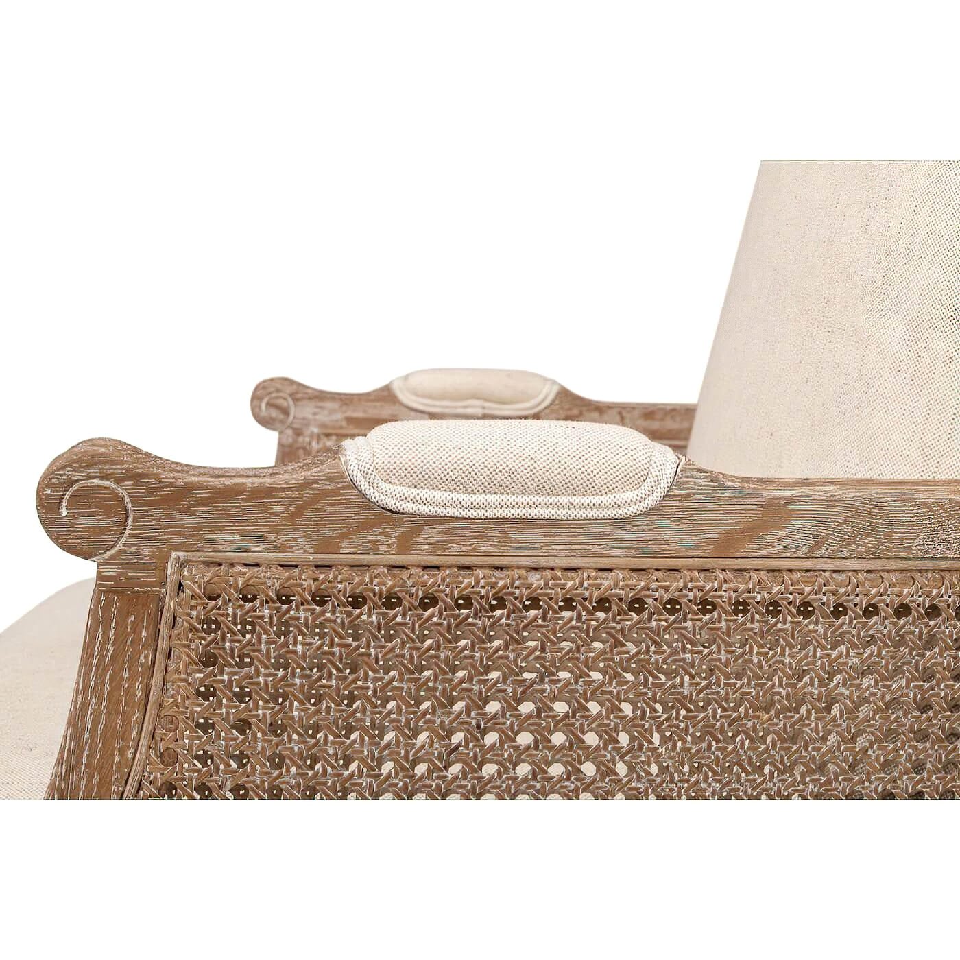 Armrest and cushioning detail on French caned armchair.