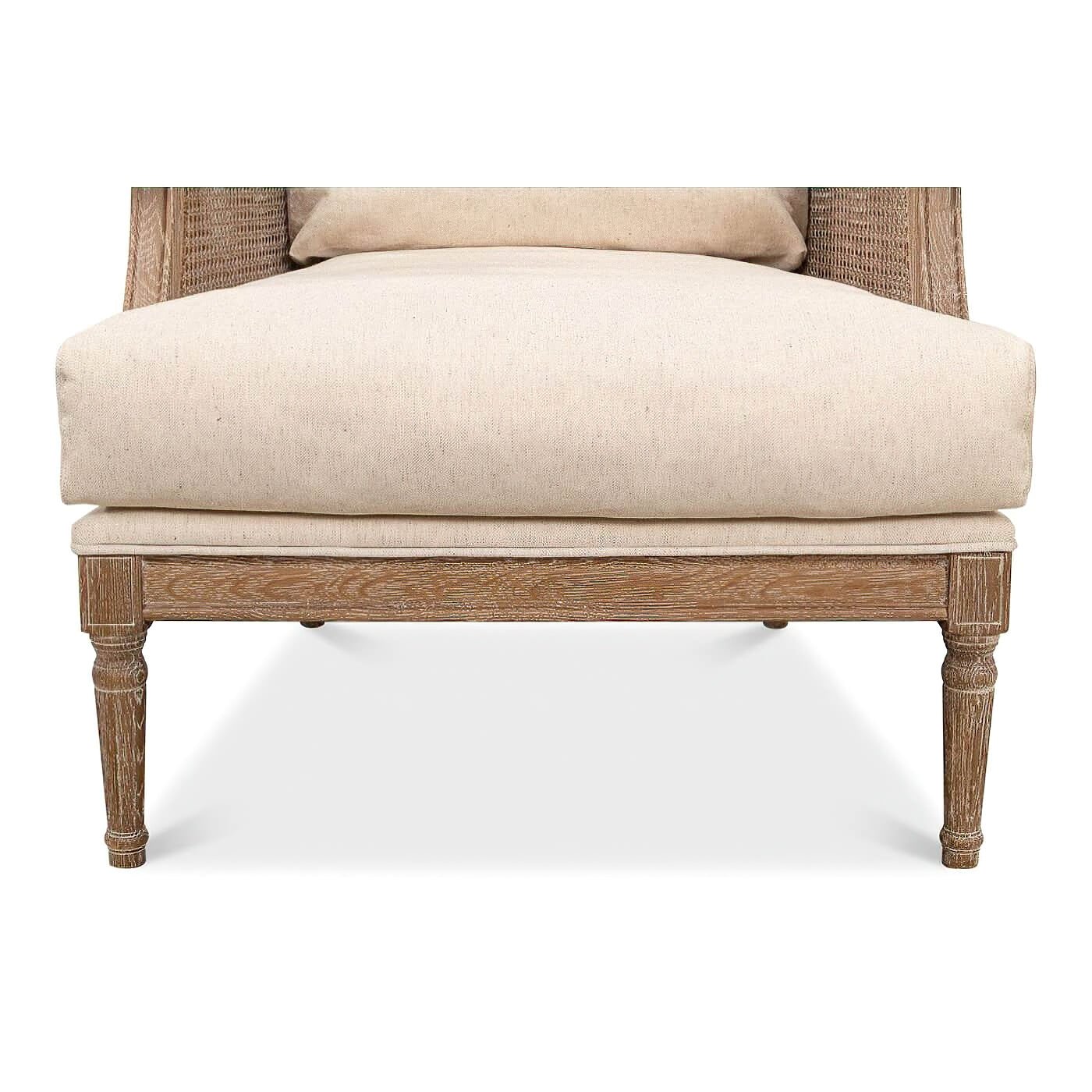 Close-up of leg and base on French caned armchair.