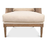 Close-up of leg and base on French caned armchair.