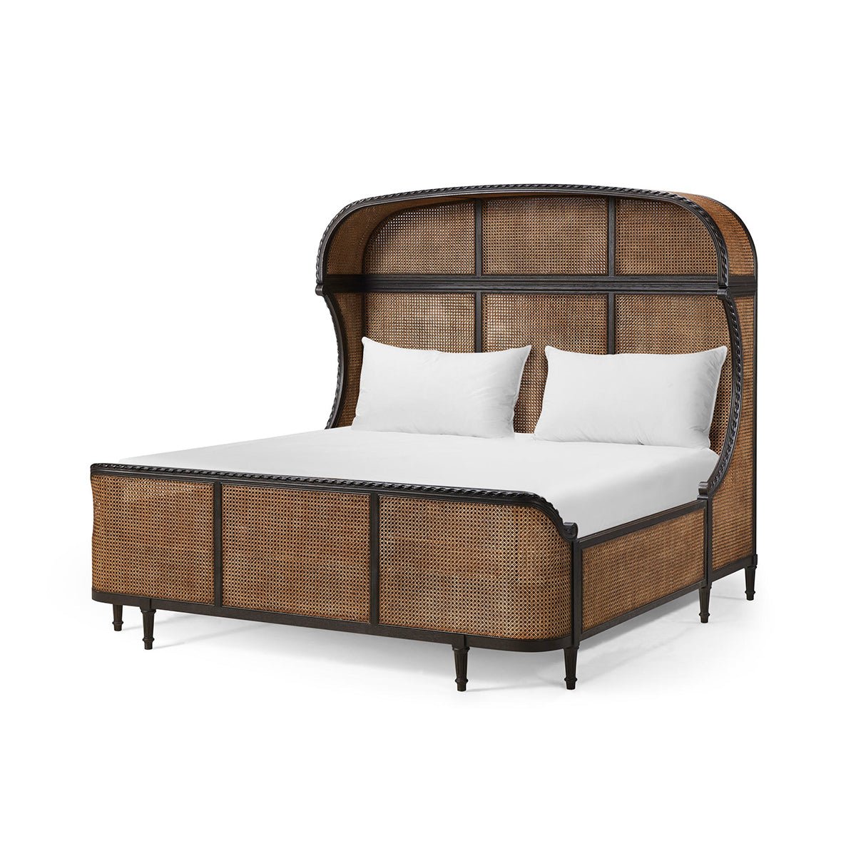 French caned king bed angled view with white pillows.