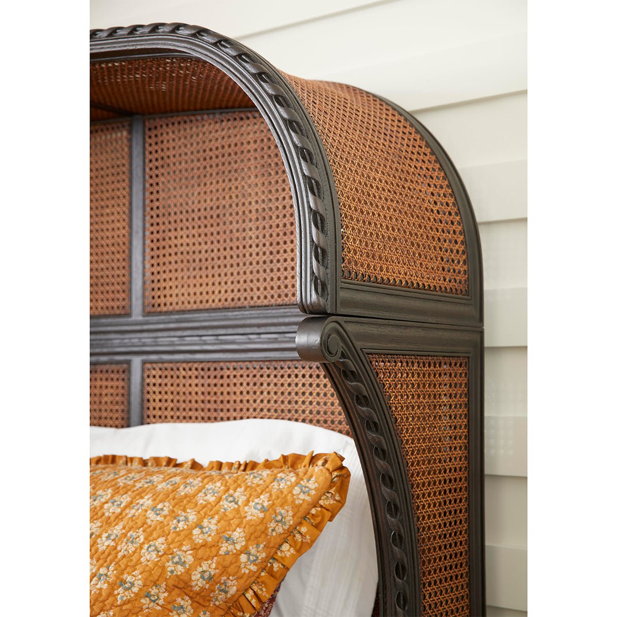 French caned king bed headboard with bedding detail.