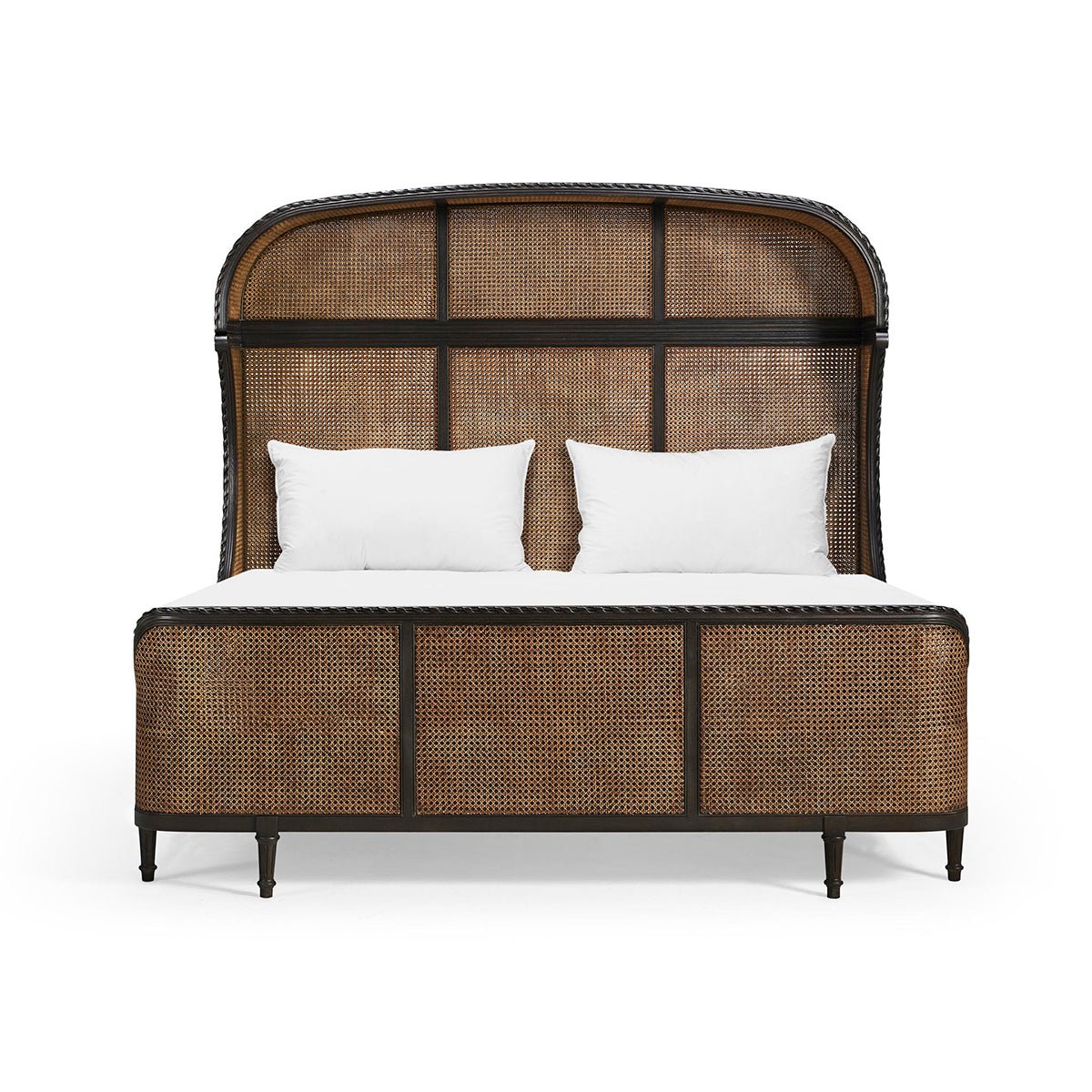 Front view of French caned king bed with pillows.