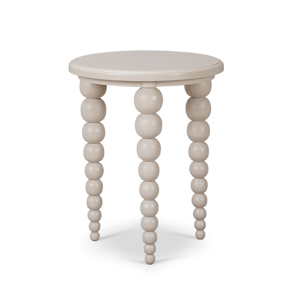 Round beaded-leg side table, beige, angled view.