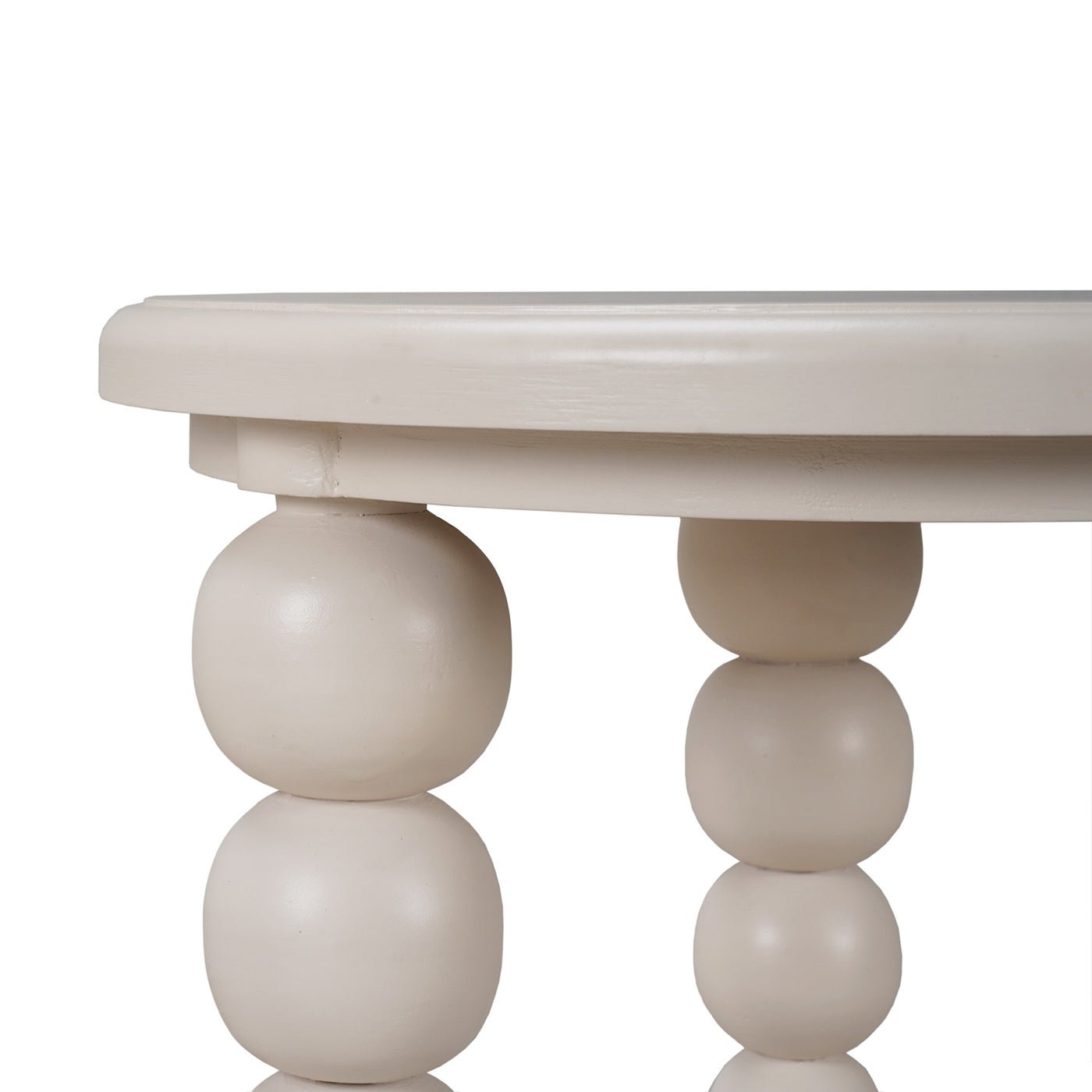 Close-up of beige beaded legs on round side table.
