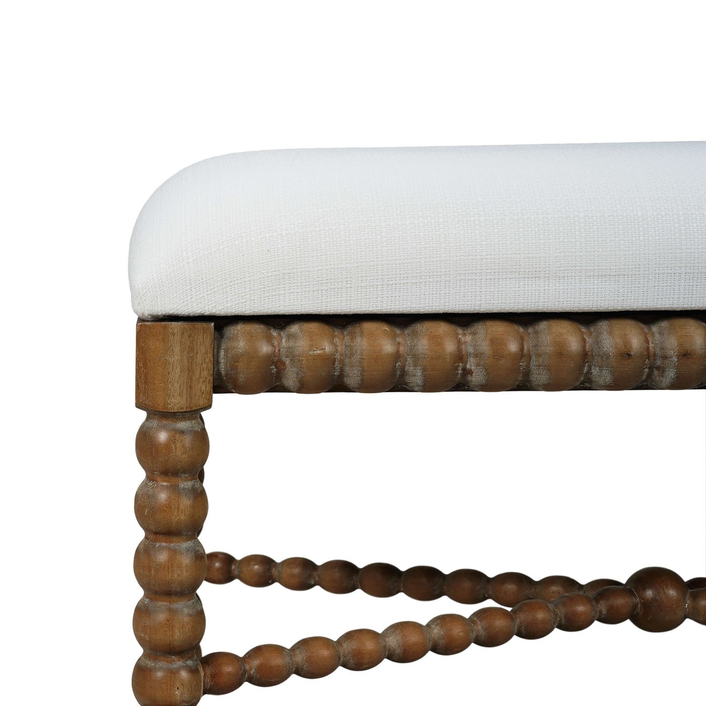 Close-up of wooden bench's leg and cushion detail.