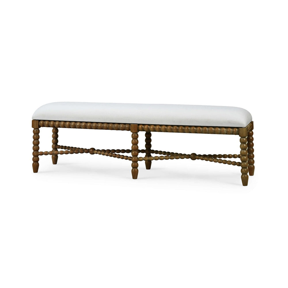 Side view of wooden bench with white upholstery.