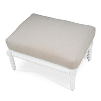 Top view of beige cushion on white bobbin ottoman.