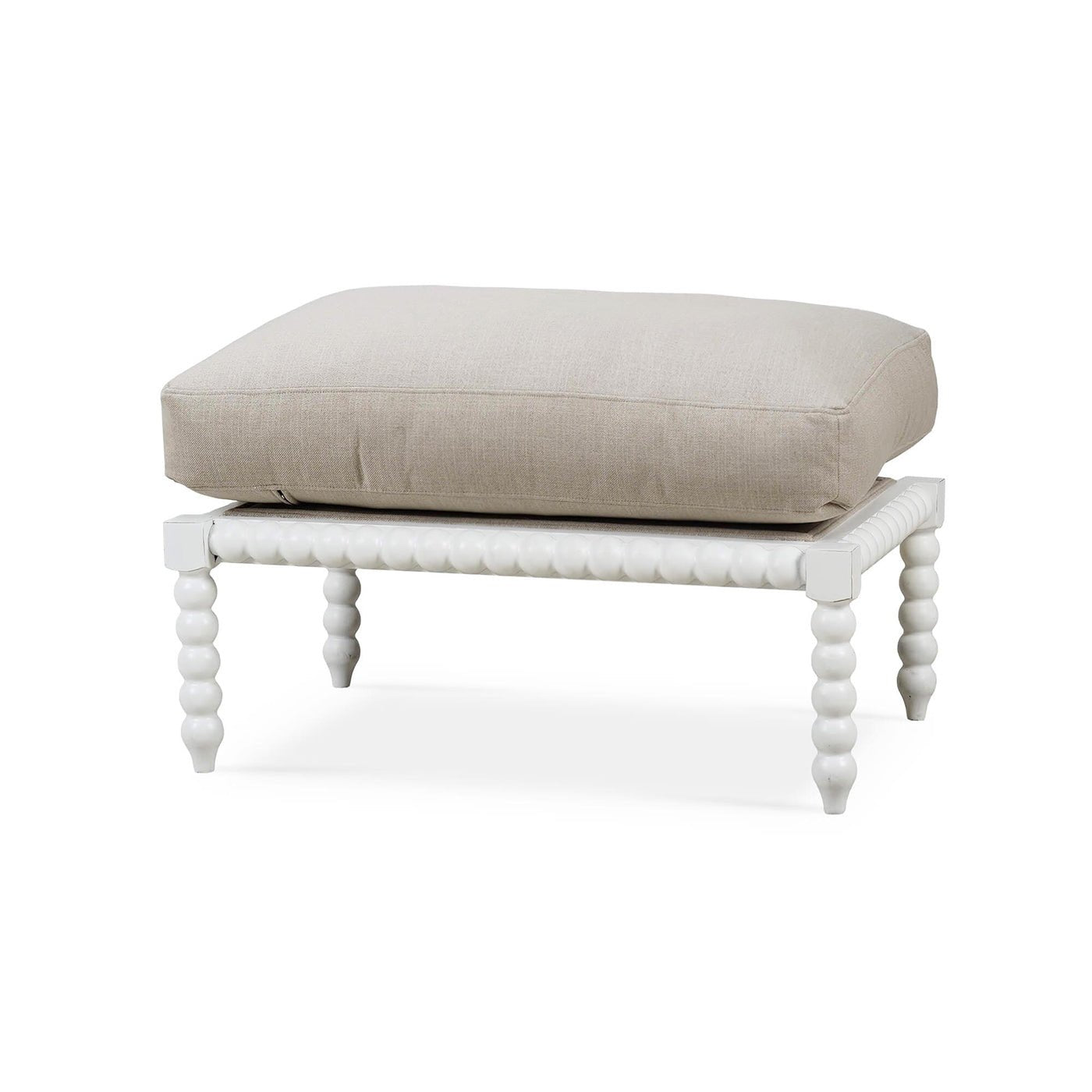 Beige cushion on white bobbin ottoman, front angle view.