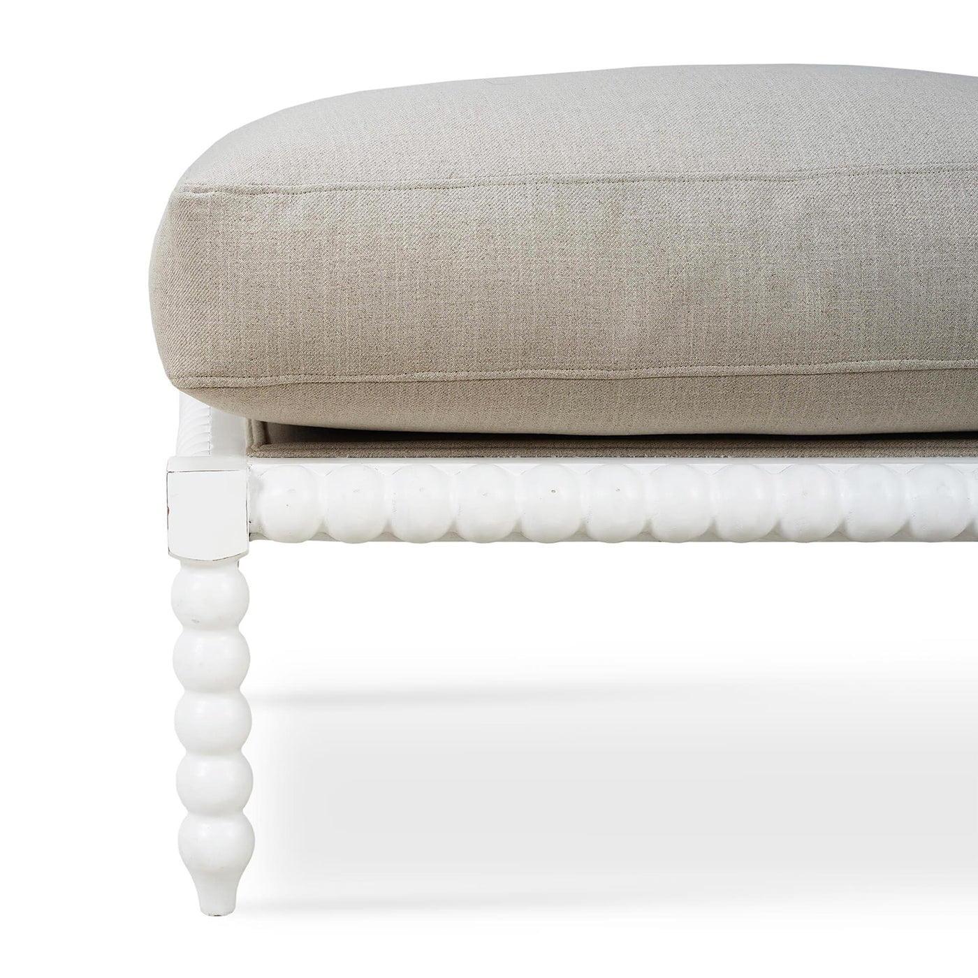 Close-up of bobbin legs and cushion on ottoman.