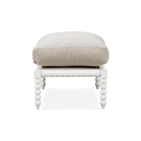 Side perspective of white bobbin ottoman with cushion.