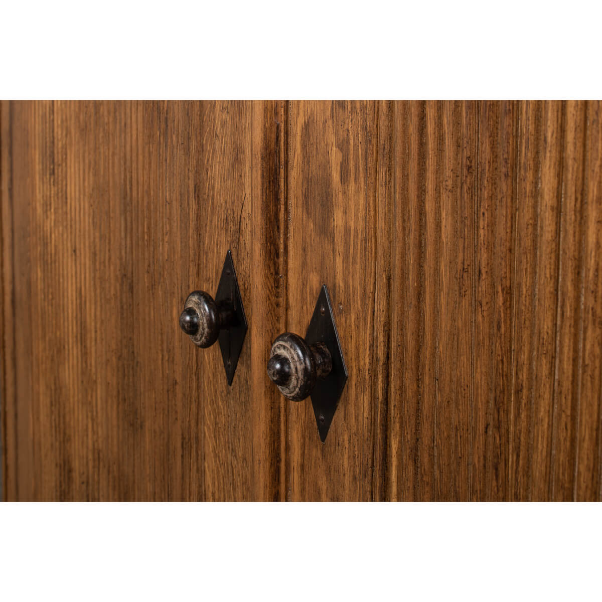 Close-up of handles on French country demilune cabinet.