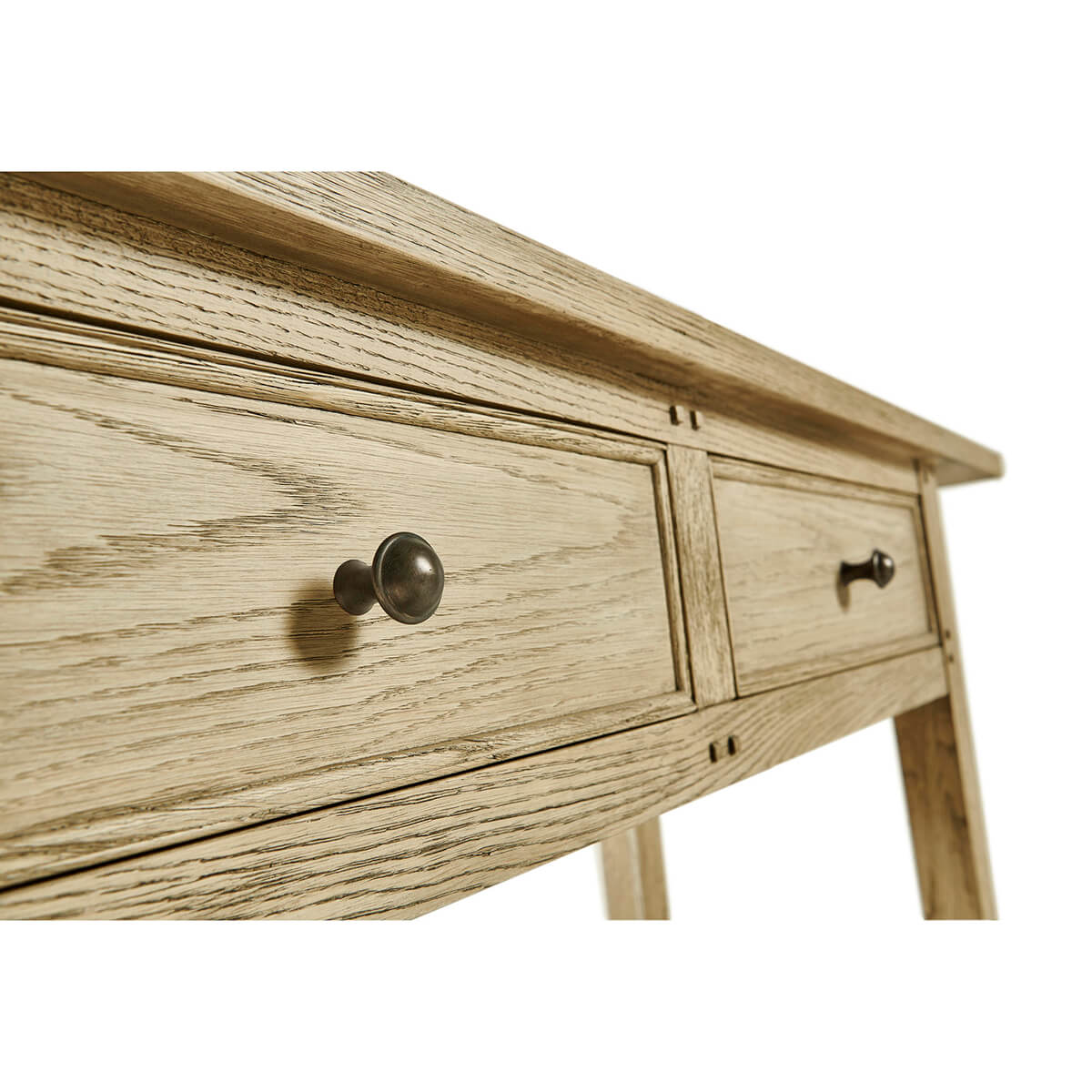 Close-up of console table twin drawers, metal knobs.