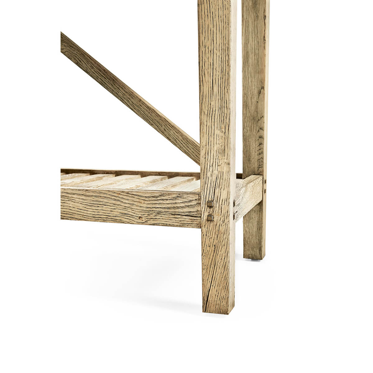 Sturdy leg and slatted shelf of console table.