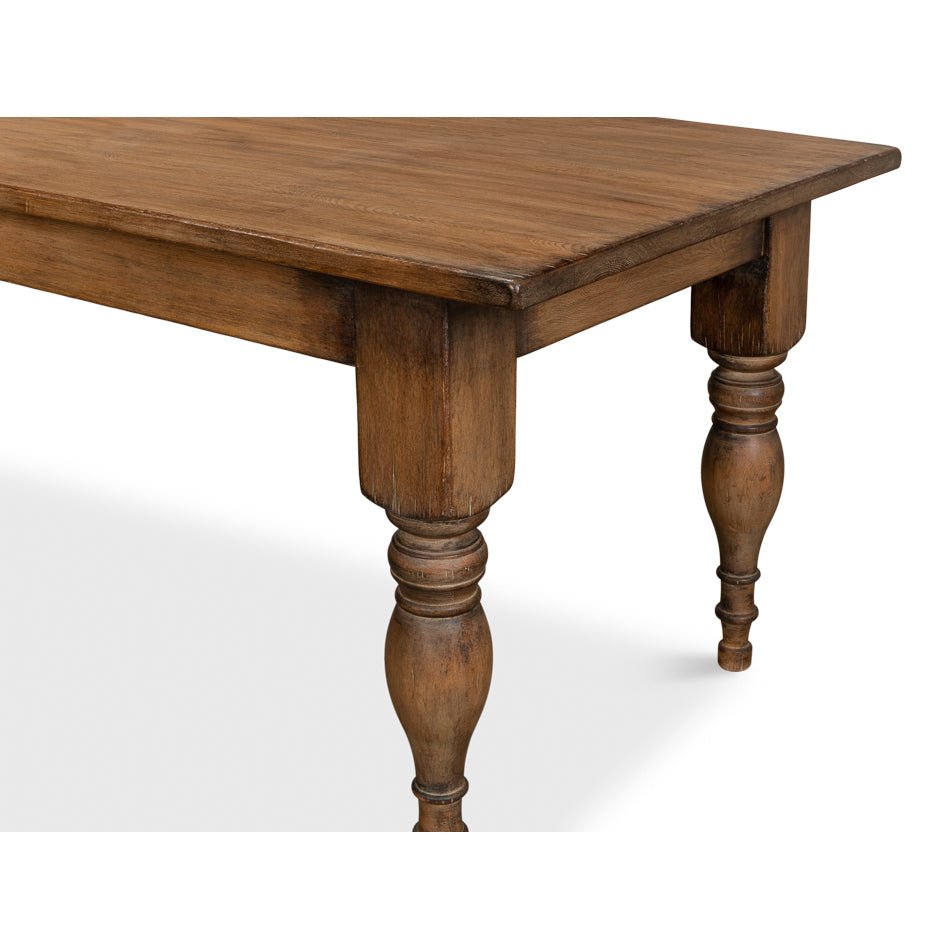 Turned legs of farmhouse dining table, close-up detail.