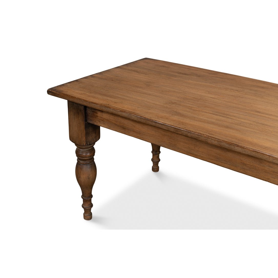 Wooden dining table corner, showcasing detailed craftsmanship.