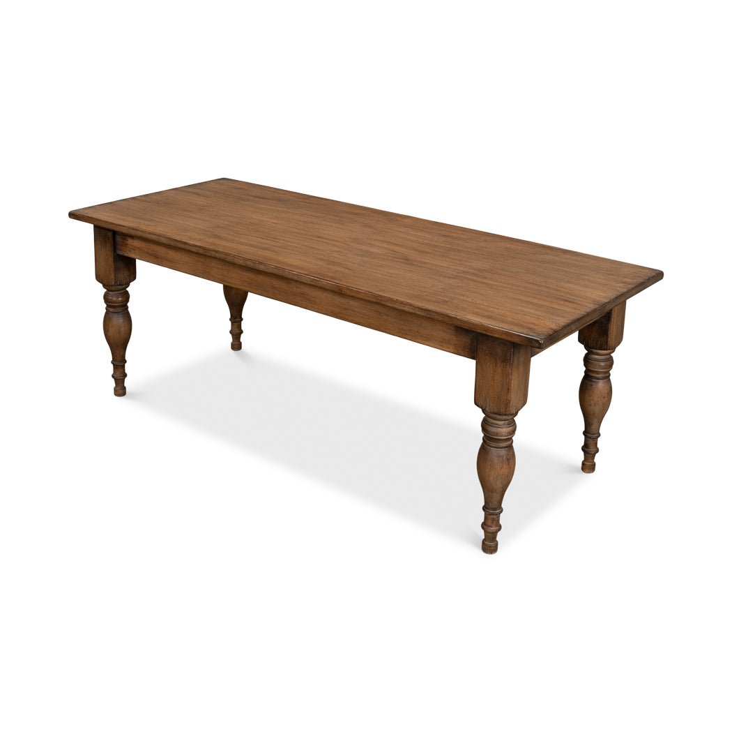 Angled view of wooden farmhouse-style dining table.