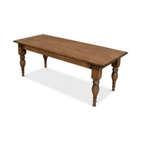 Angled view of wooden farmhouse-style dining table.