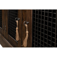 Close-up of tassel handles on buffet doors.