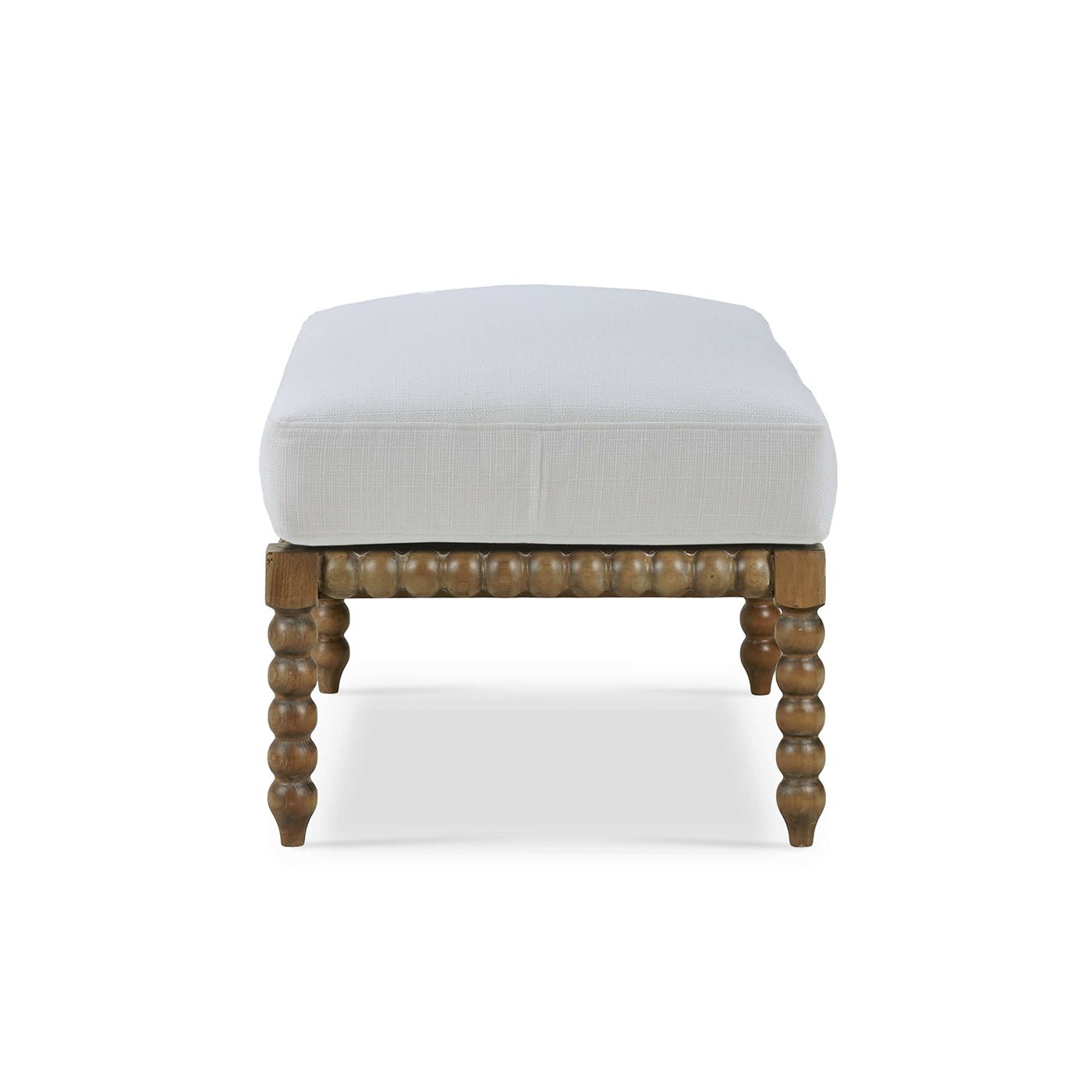 White cushioned ottoman, detailed side view of craftsmanship.