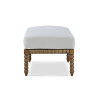 White cushioned ottoman, detailed side view of craftsmanship.