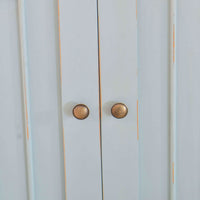 Close-up of sideboard door knobs and panel details.