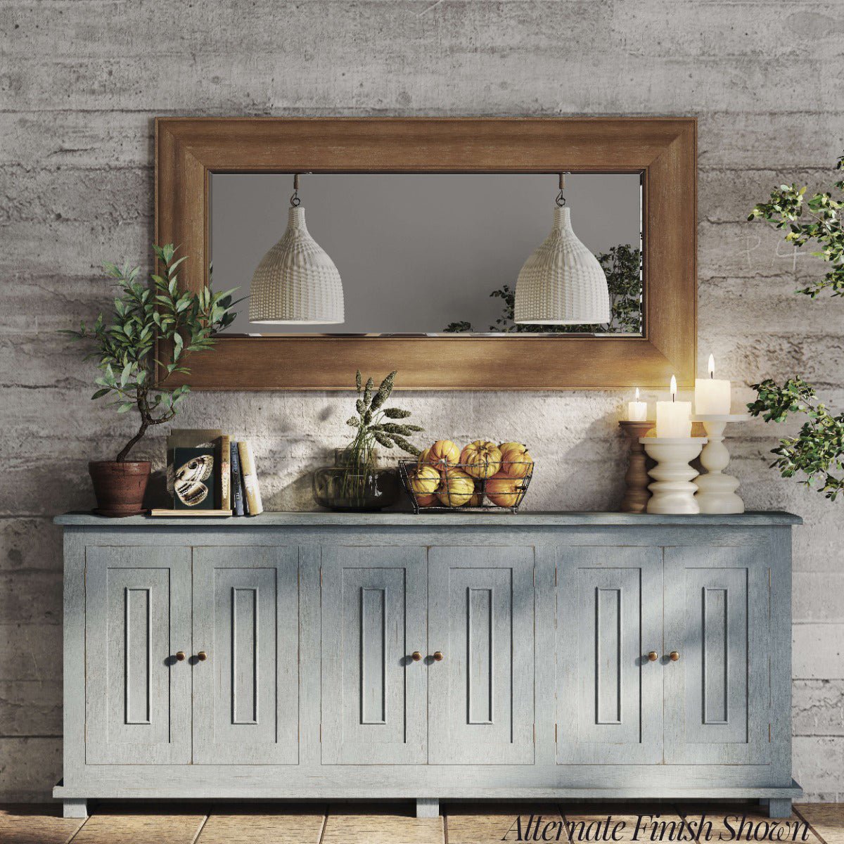 French Country sideboard under mirror with decor items.