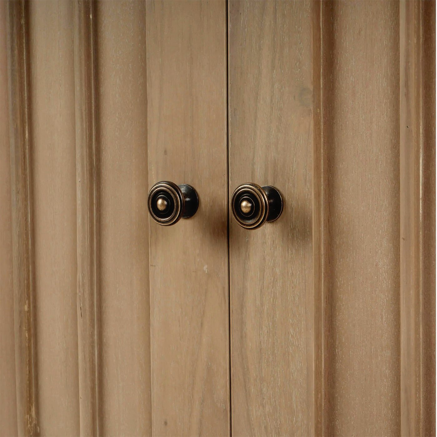 Close-up of sideboard door knobs, detailed view.