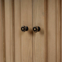 Close-up of sideboard door knobs, detailed view.