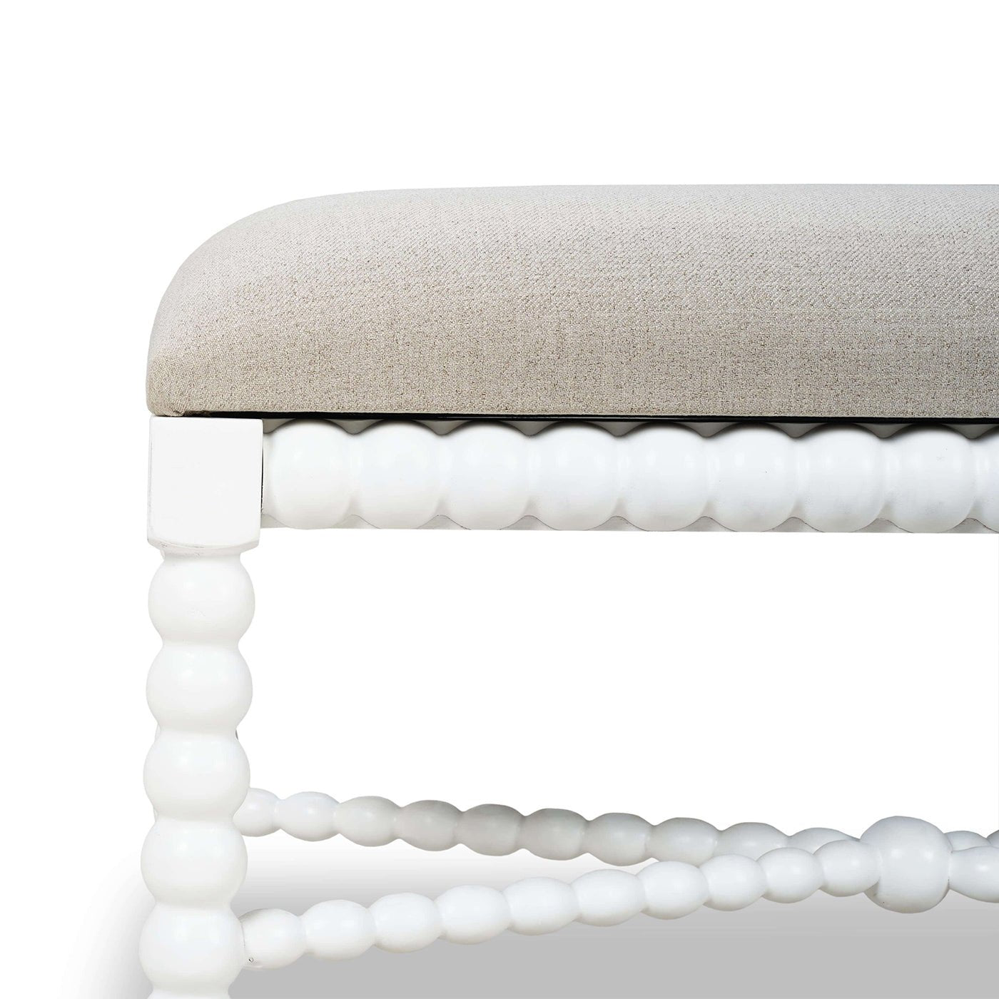 Close-up of white bench's decorative legs and seat.