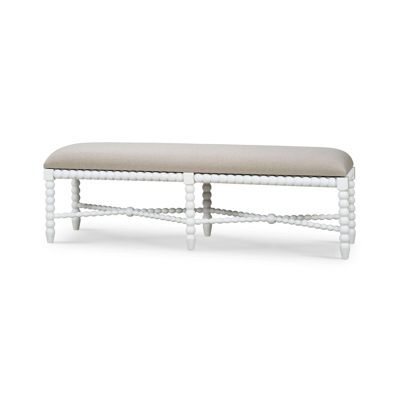 White painted bench with light fabric seat, front view.