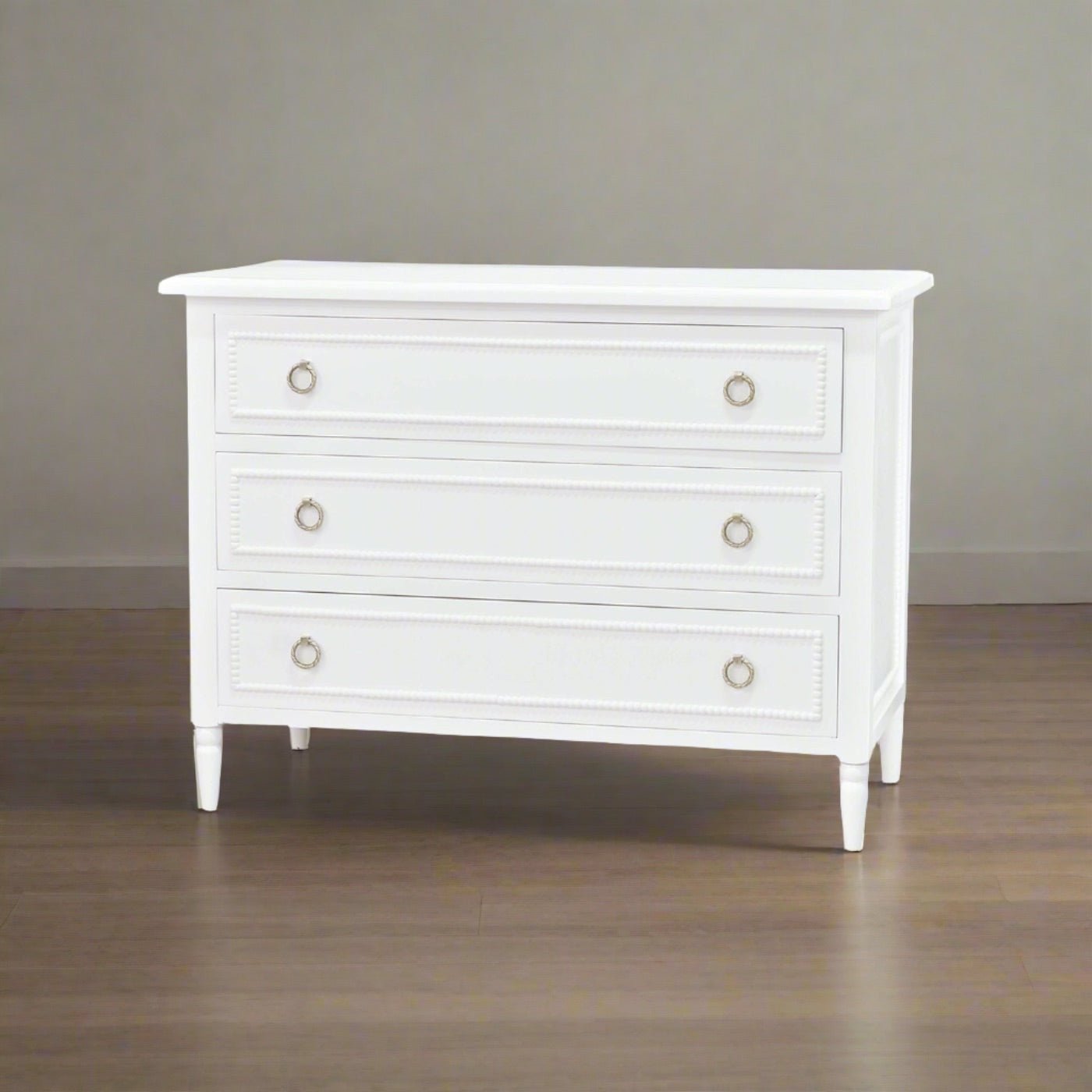 White chest of drawers, angled room view.